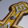 A close up a golden cross applique which shows the the quality and detail of our Orthodox embroidery.