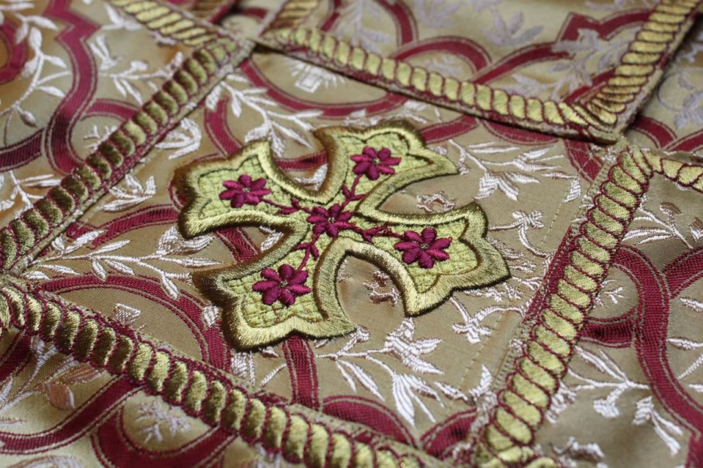 An ambroidered applique on a chalice veil