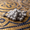 The inspiration for Byzantine incense: a pile of the finished product resting on the surface of a Byzantine mosaic with gold and blue tiles.