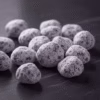 A macro, close-up shot of hand-cut Night Flower incense pieces, showing their magnesia coating.
